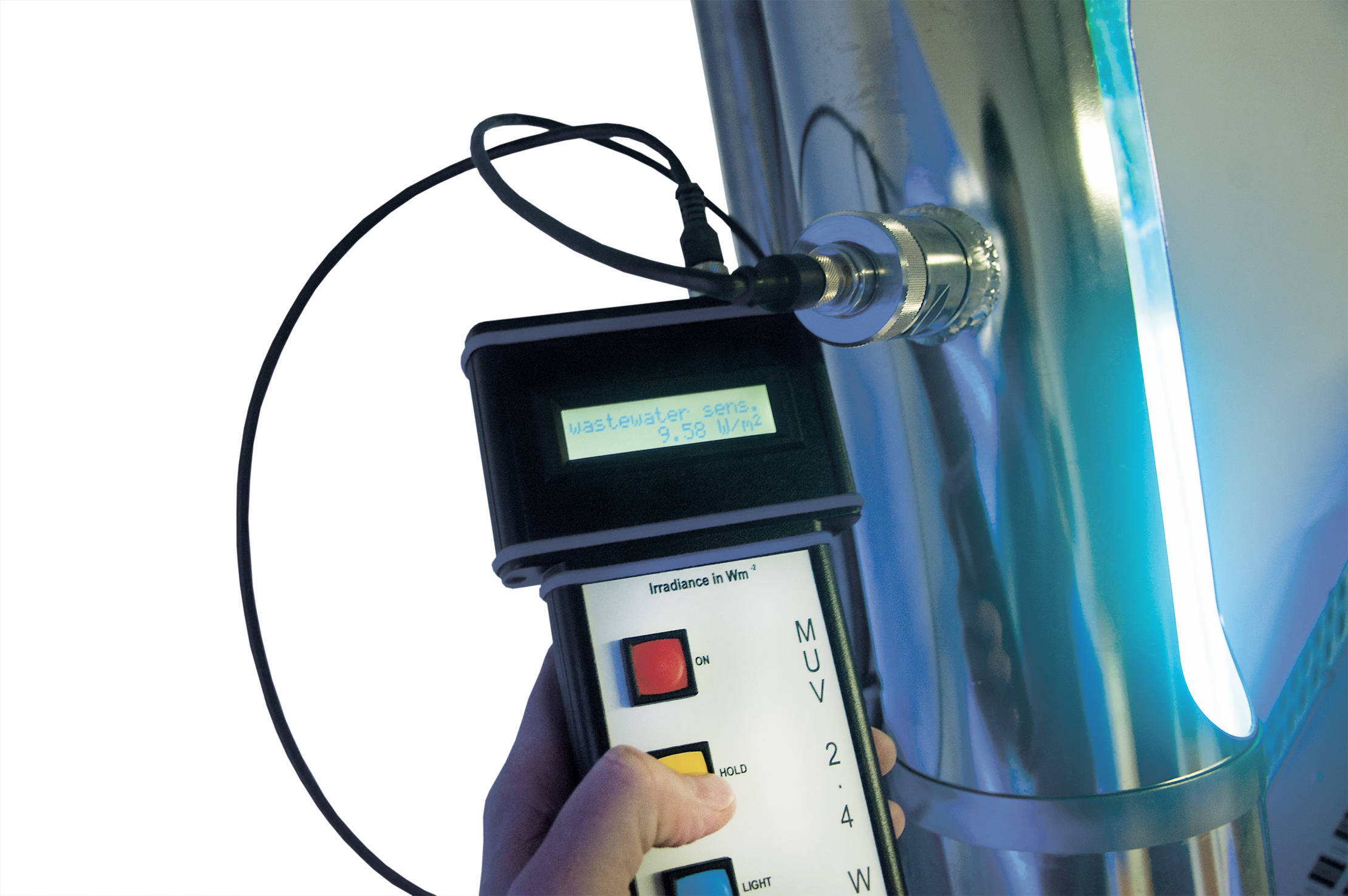MUV2.4 / KUV2.4 UV Sensor Check Person holding MUV2.4 / KUV2.4 UV measurement device checking water plant sensor; device displays critical measurement.
